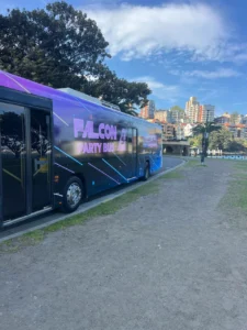 Colorful party bus parked by pathway.