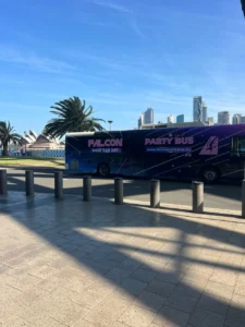 Colorful party bus near city skyline.
