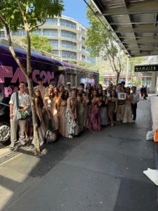 Group of people near party bus.