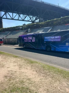 Colorful party bus near bridge.