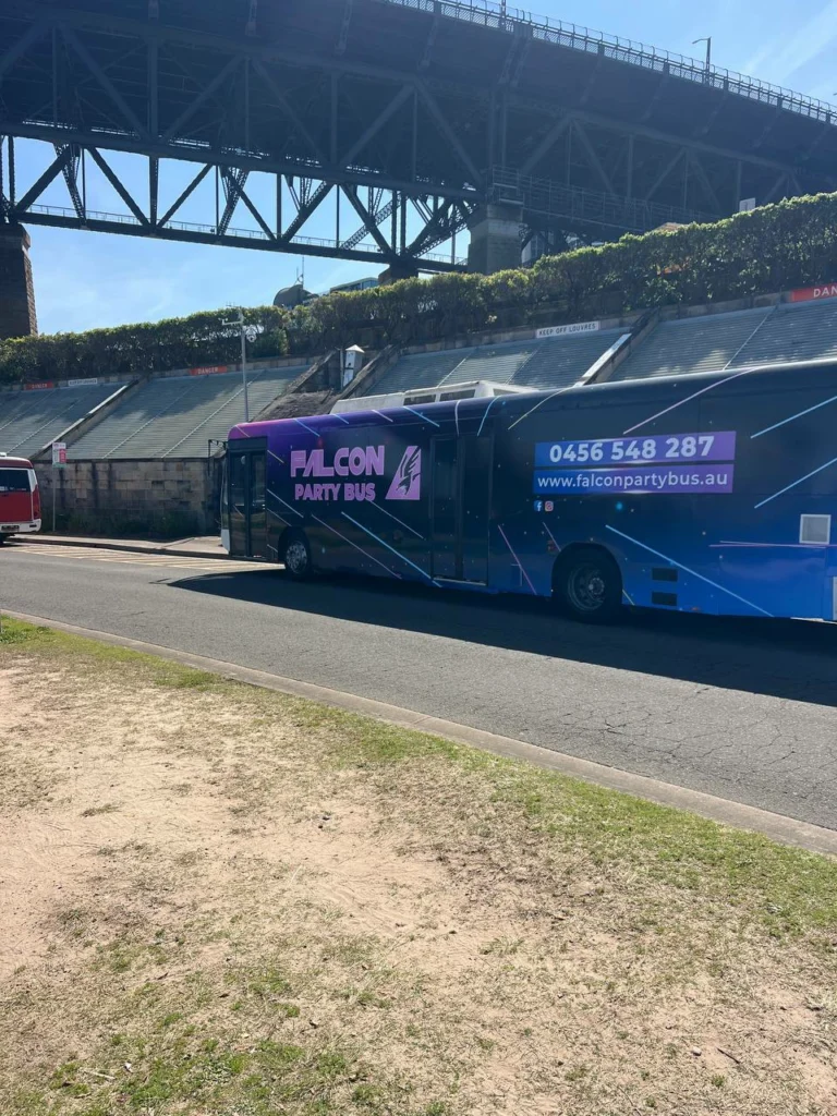Book Now 6 Colorful party bus near bridge.