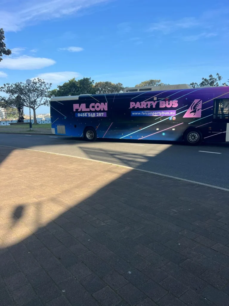 Book Now 3 Colorful party bus parked outdoors.